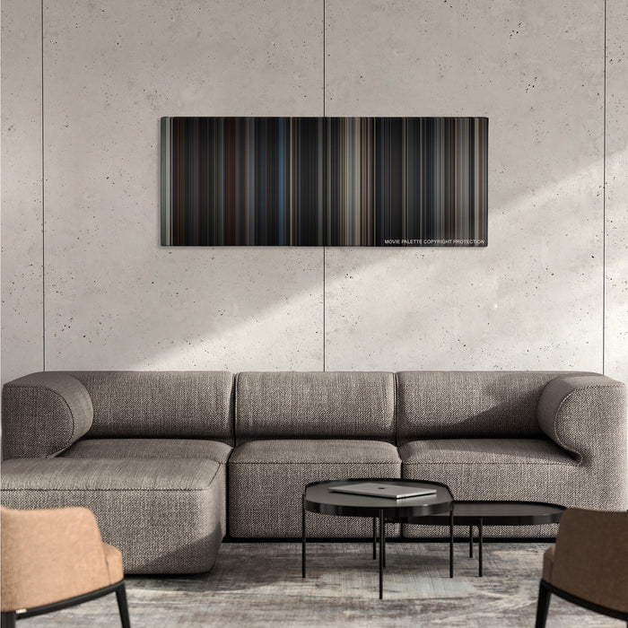 The Dark Knight Rises color palette canvas on a concrete wall above a gray sectional sofa