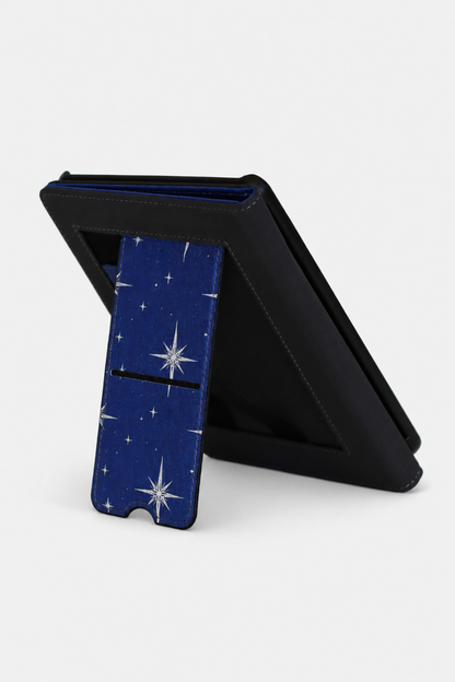 A black tablet case with a blue starry pattern on the front cover, shown standing open on a light gray background.