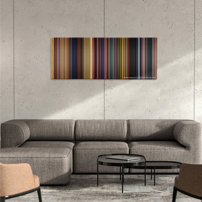The Prince of Egypt color palette canvas on a concrete wall above a gray sectional sofa