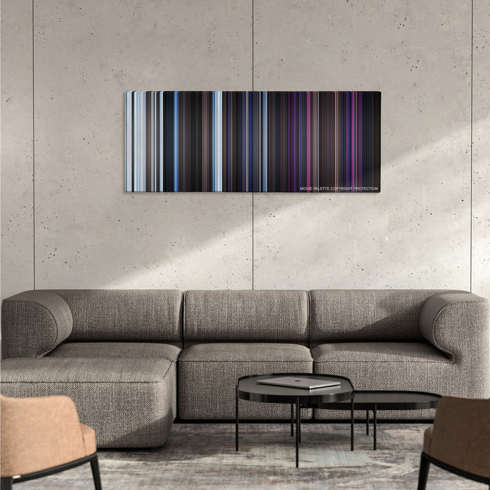 The Thing color palette canvas on a concrete wall above a gray sectional sofa